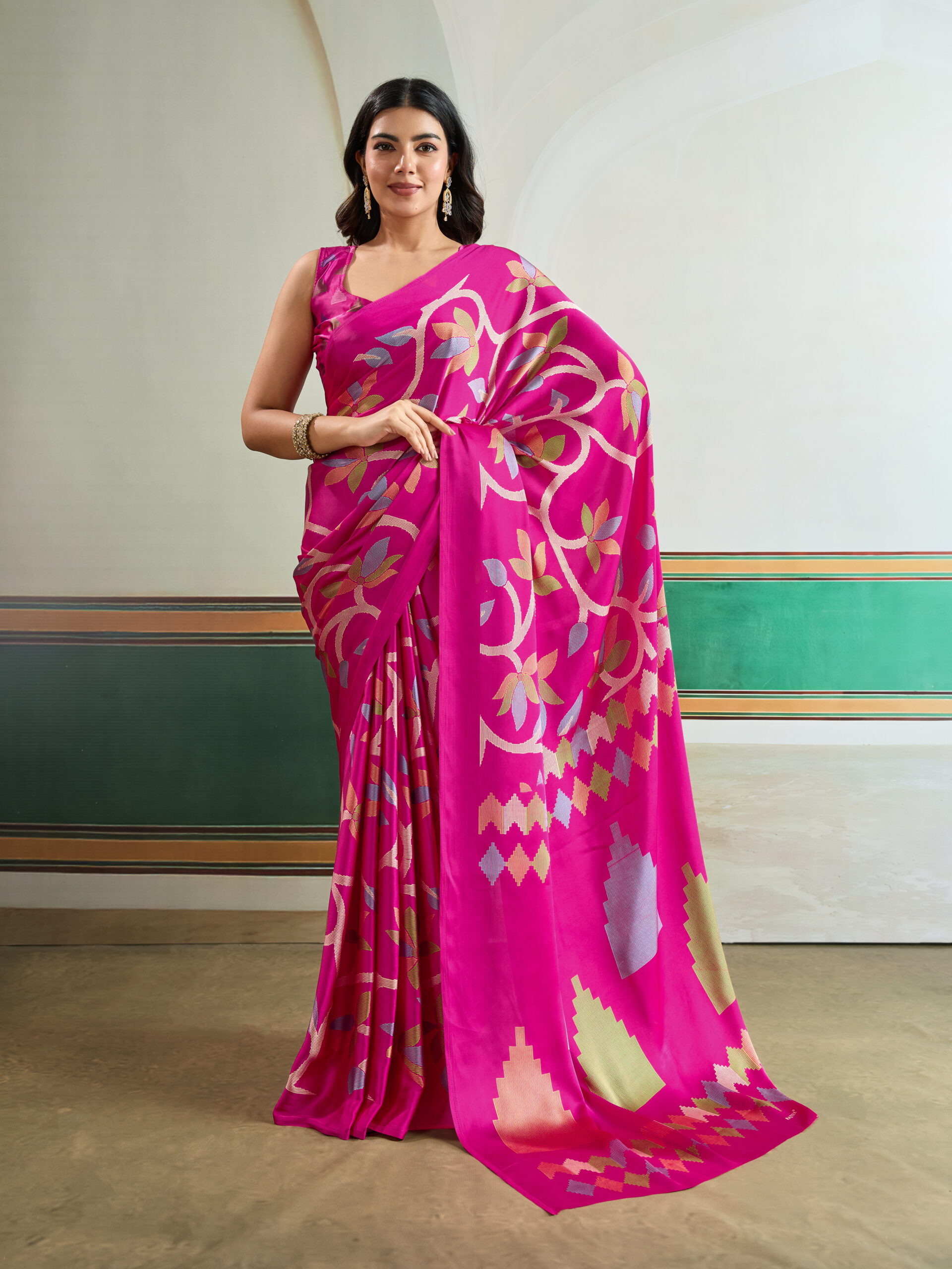 "Vibrant Fuchsia Bloom Art Silk Saree: A bright pink saree featuring multi-colored botanical vines and modern geometric 'step' patterns on a lustrous silk-finish base."