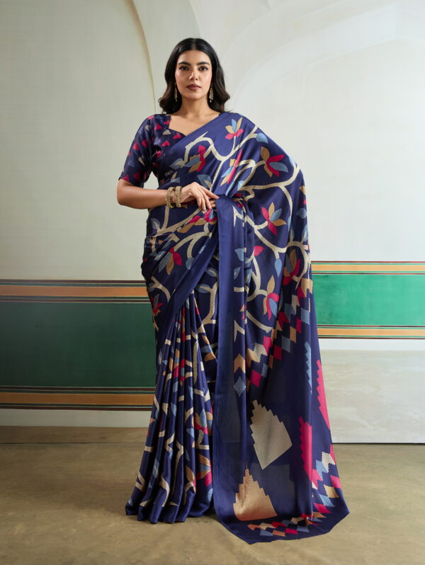 "Regal Navy Geometric Art Silk Saree: A deep navy blue saree featuring vibrant rani pink and sky blue botanical vines with modern architectural 'step' patterns on a lustrous silk-finish base."