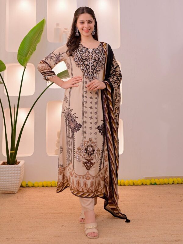 Woman wearing a beige and black straight salwar kameez featuring intricate floral and geometric prints, an ornate neckline, and a black contrast dupatta with tassel details."