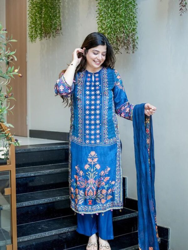 Women's royal blue silk kurta set with vibrant floral embroidery and matching dupatta.